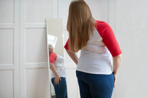 woman looking at herself in the mirror