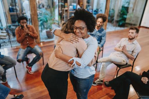 people supporting each other and hugging