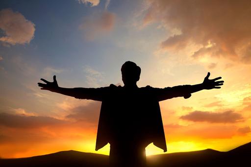 sunset silhouette of man with arms out