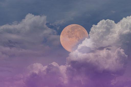 full moon behind clouds