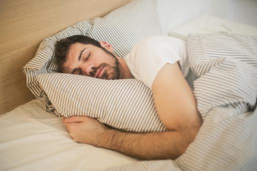 middle aged man asleep in bed