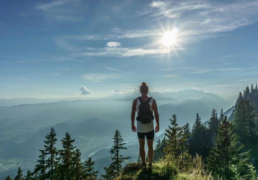 lady hiking and standing overlooking mountain