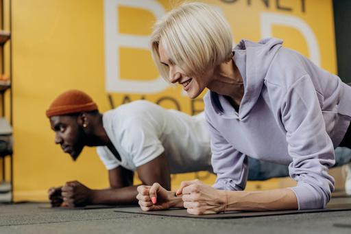 man with older woman training in gym